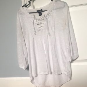 A white flowy high low with a V-neck cut out